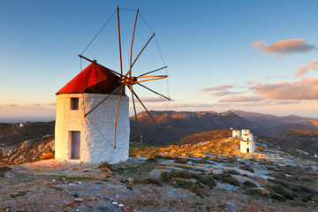 Windmills over  Chora of Amorgos island early in the morning. - obrazy, fototapety, plakaty