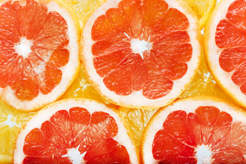 background of citrus fruits oranges and grapefruit slices. Studi