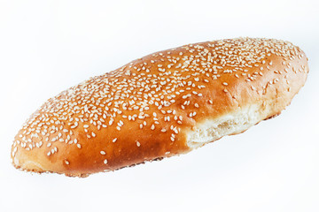 bun sprinkled with sesame seeds on a light background. insulatio
