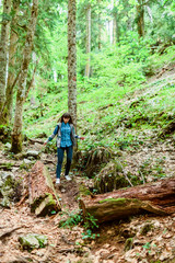 Naklejka premium Girl in hike. Traveler in mountain forest