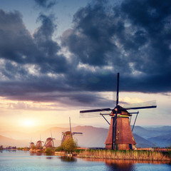 Colorful spring day with traditional Dutch windmills canal in Ro