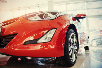 Naklejka premium Headlights and hood of sport red car.