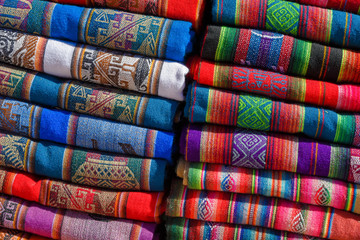 A pile of colorful rugged Peruvian textile and fabrics.