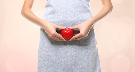 Gynecology concept. Young woman on color background