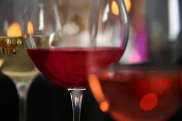 Three glasses with tasty wine on bright background, closeup