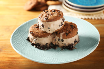 Delicious cookies with ice cream and chocolate chips on plate