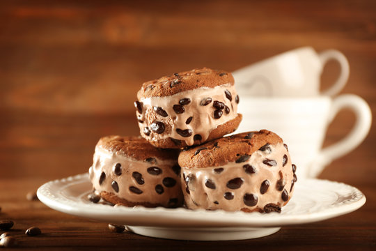 Delicious cookies with ice cream and chocolate chips on plate