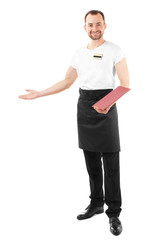 Handsome waiter with menu on white background