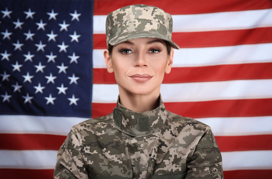 Portrait of female soldier with USA flag on background