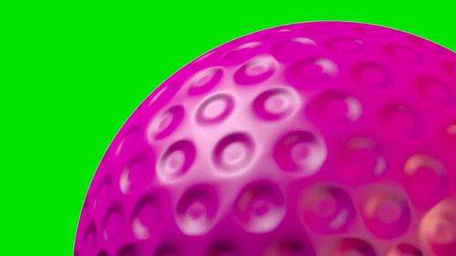 A closeup of a traditional pink lawn hockey ball with a dimpled surface rotating once to create a loop able sequence on a green screen background - 3D render