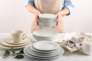 Closeup of female hands holding saucers