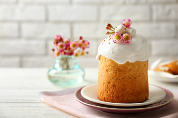 Plates with sweet Easter cake on table