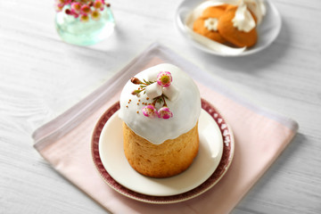 Plates with sweet Easter cake on table