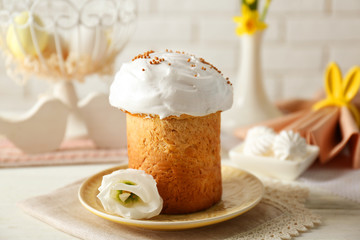 Plate with sweet Easter cake on table