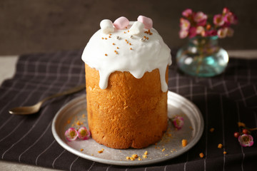 Plate with sweet Easter cake on table