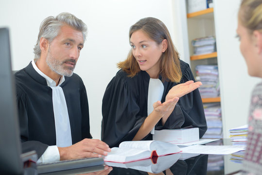 Lawyers talking with client