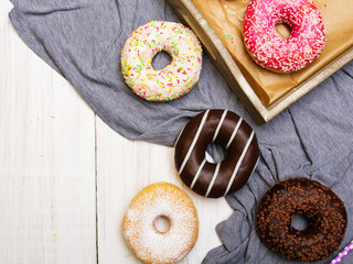 Colorful donuts with chocolate and icing, selective focus