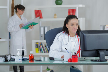 concentrated doctor working with a computer