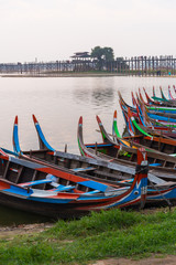 Fototapeta na wymiar wooden local tourist sight seeing boat front of U Bein wooden bridge in Myanmar