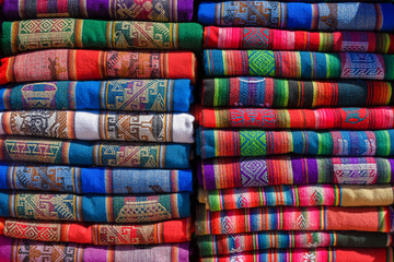 A pile of colorful rugged Peruvian textile and fabrics.