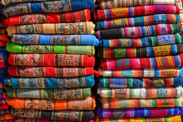 A pile of colorful rugged Peruvian textile and fabrics.