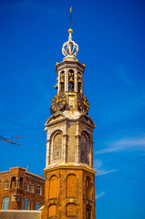 Fototapeta na wymiar Munttoren clock tower to the rear at Muntplein, Amsterdam, Netherlands,