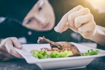 The chef prepares a gourmet meal.