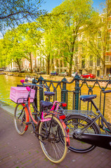 Obraz premium Bikes on the bridge in Amsterdam, Netherlands. Canals of Amsterdam.