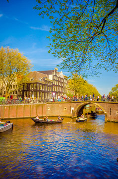 Traditional old buildings and boats in Amsterdam, Netherlands. Canals of Amsterdam.