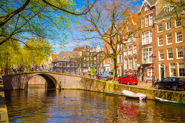 Traditional old buildings and boats in Amsterdam, Netherlands. Canals of Amsterdam.