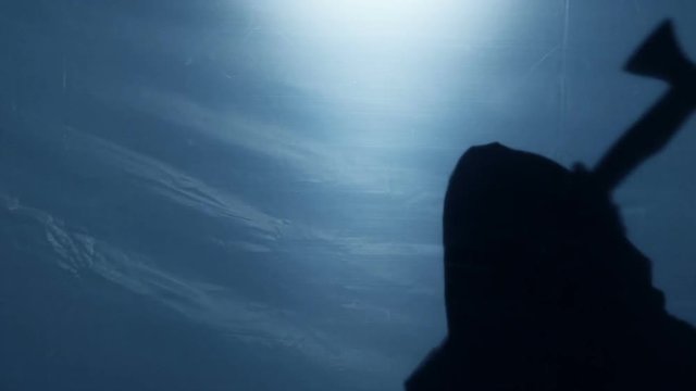 Crazy aggressive murderer in gown chopping victim with axe, horror nightmare