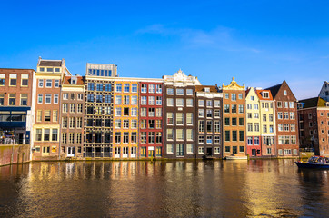 Naklejka premium Traditional old buildings and boats in Amsterdam, Netherlands. Canals of Amsterdam.