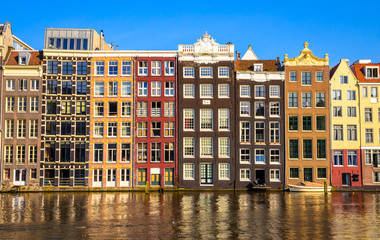 Traditional old buildings and boats in Amsterdam, Netherlands. Canals of Amsterdam.