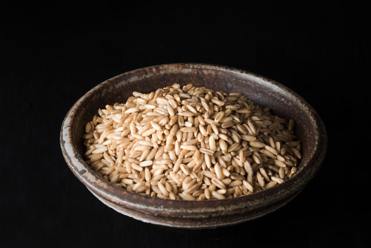 Oat groats in a pottery bowl