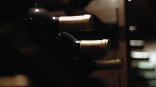 Close up of vintage wine bottles on a wooden rack