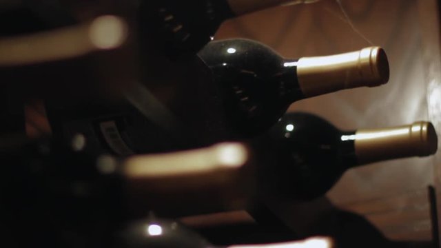 Close up of vintage wine bottles on a wooden rack