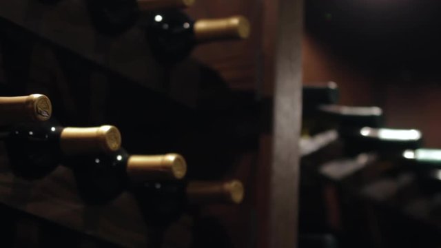 Close up of vintage wine bottles on a wooden rack