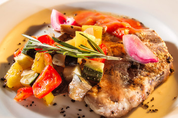 Meat pork stewed with vegetables on a plate.