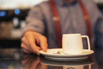 Fototapeta na wymiar Waiter holding a tray with coffees.