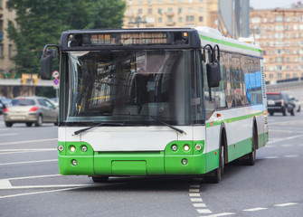 bus goes along street