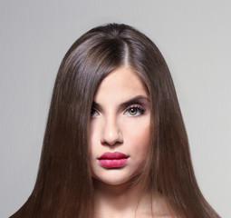 Young woman with healthy hair on light background