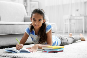 Cute girl doing lessons at home