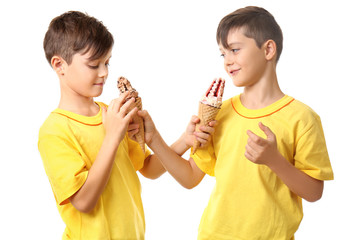 Cute boys with ice cream on white background