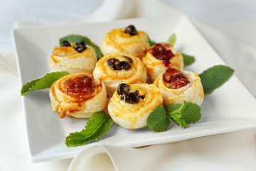 Tasty puff pastry with berries on plate