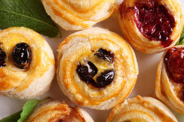Tasty puff pastry with berries on plate, closeup