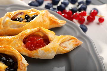 Tasty puff pastry with berries on plate