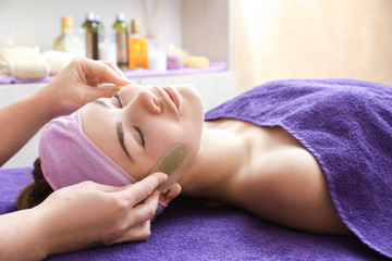 Obraz na płótnie Canvas Face massage with jade stones in spa center