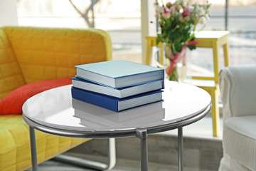 Pile of books on table at home