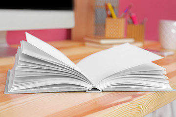 Opened book on office table, closeup