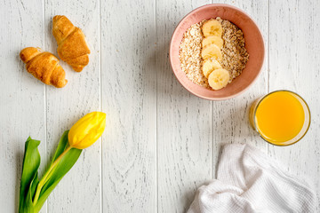 Fototapeta na wymiar healthy breakfast with porridge on wooden background top view